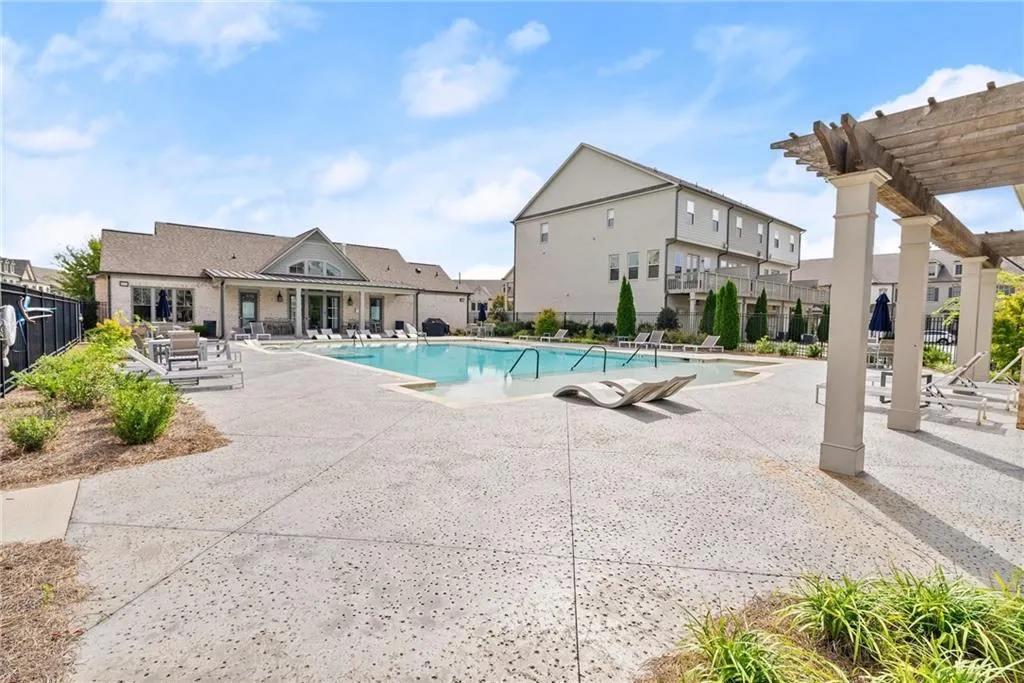 Community pool featuring a patio area and a pergola