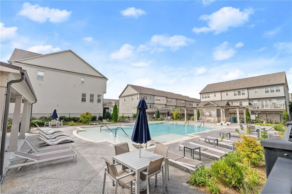 Community pool featuring a patio and a residential view