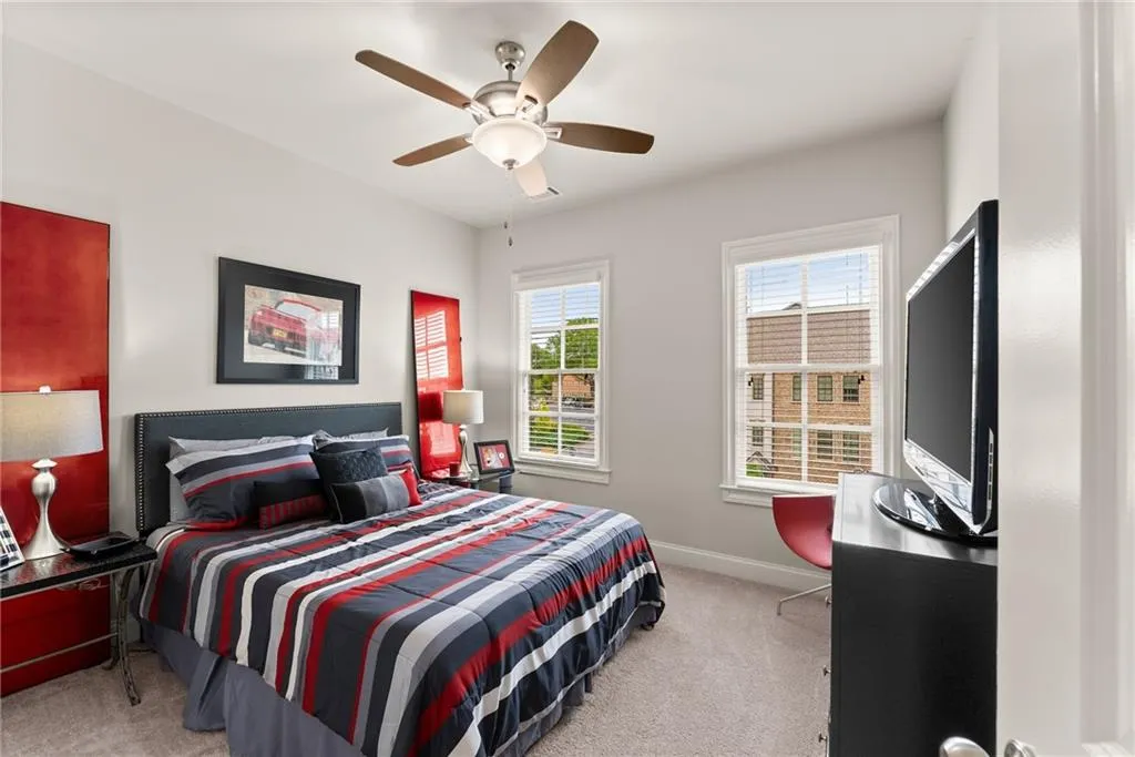 Bedroom featuring light carpet and a ceiling fan