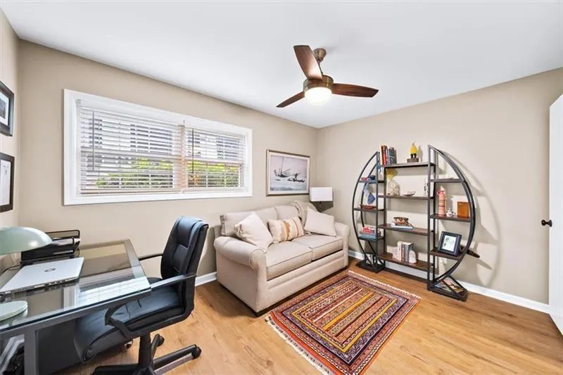 Office space with light wood-style flooring and ceiling fan