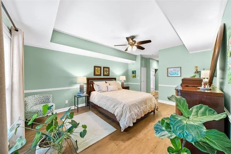 Bedroom featuring wood finished floors and a ceiling fan