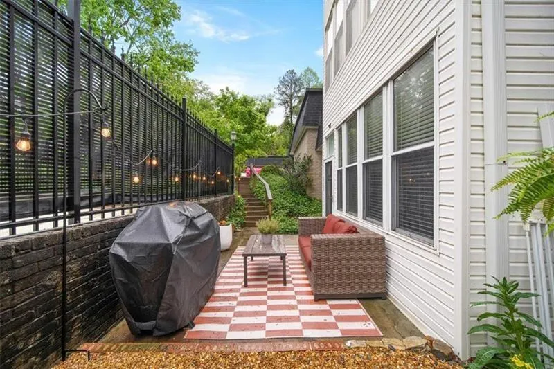 View of side of home with a patio and an outdoor living space