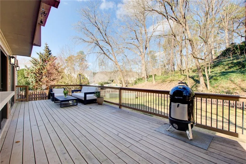 Large deck featuring grilling area and plenty of space for family and friends