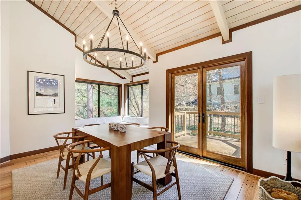 Dining room with light wood-type flooring, french doors, a vaulted wooden ceiling, and hanging lights