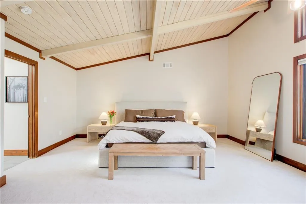 Spacious primary suite with vaulted windows, a spa like bath and a walk in closet