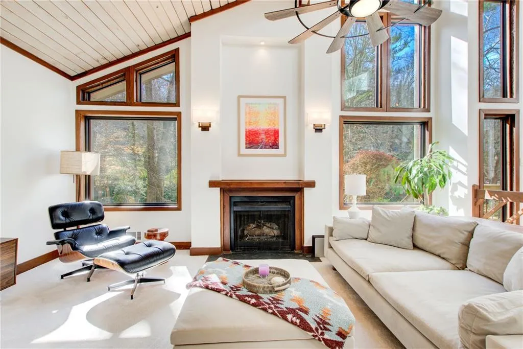 Take a look at this spacious  fireside family room with beautiful floor to ceiling windows.