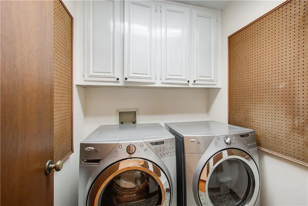 Laundry area featuring cabinet space and washing machine and clothes dryer