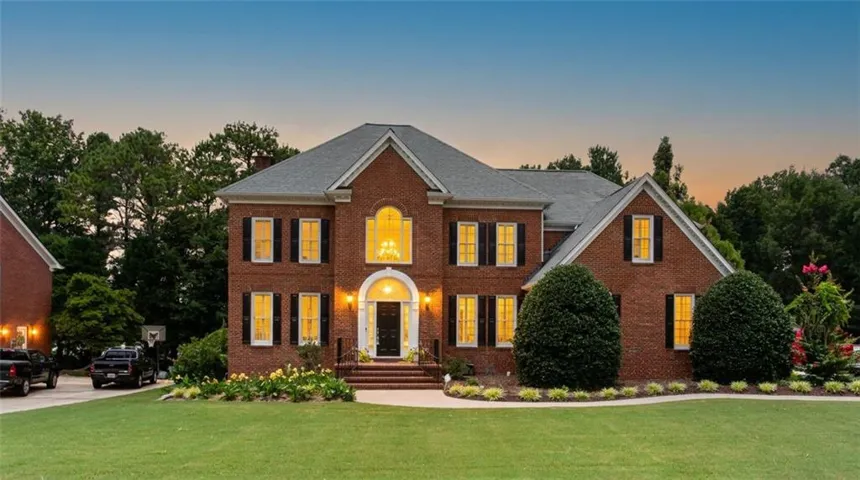 Brick exterior with a gabled roof and arched entryway