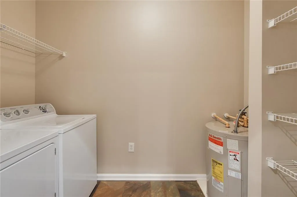 Washroom with washing machine and dryer and electric water heater