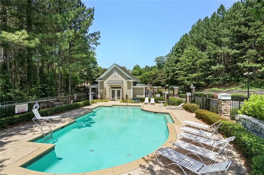 Community pool featuring french doors and a patio area