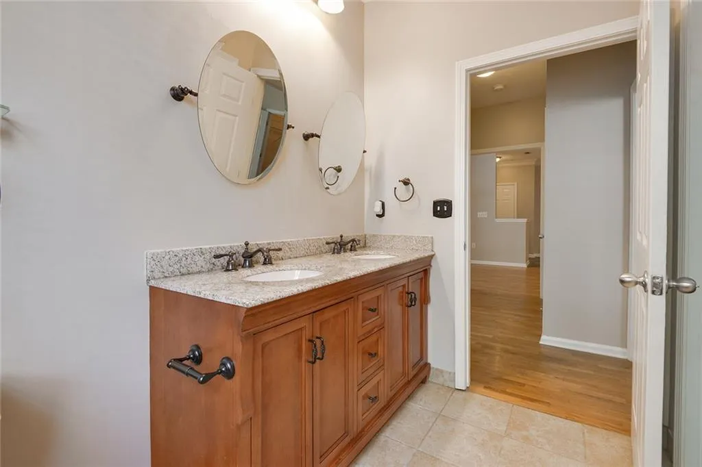 Bathroom with tile patterned floors and double vanity
