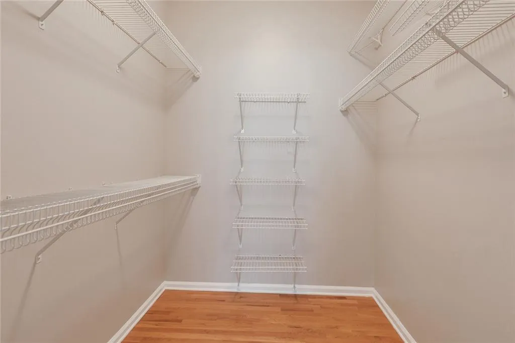 Spacious closet featuring light wood-style flooring