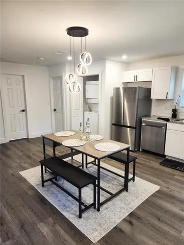 Open-concept living space with wood-finish flooring