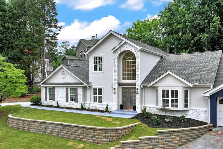 White painted brick and stucco exterior