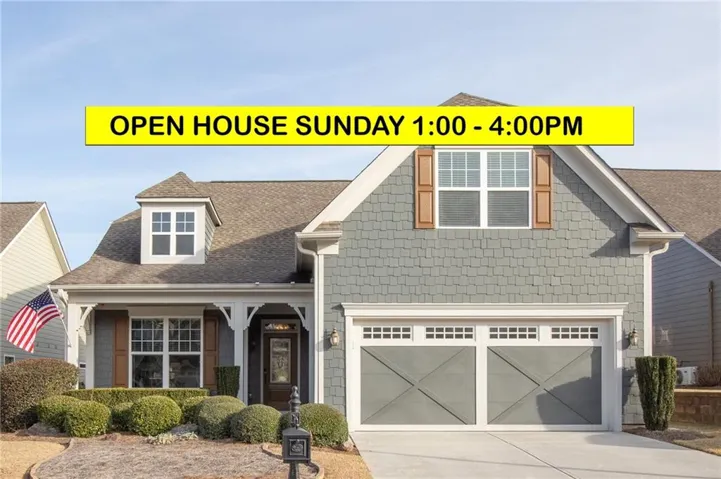 Gable roofline, decorative front porch columns, front-facing dormer, shaker-style siding, and a two-car garage with cross-brace detailing