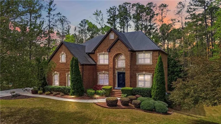 Brick exterior with a dark roof and multiple gables