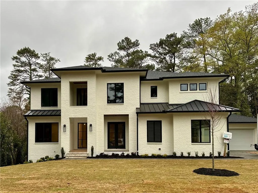 View of front facade with a front lawn and a garage