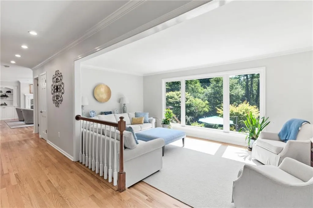 Oversized picture window provides pool and lush backyard views