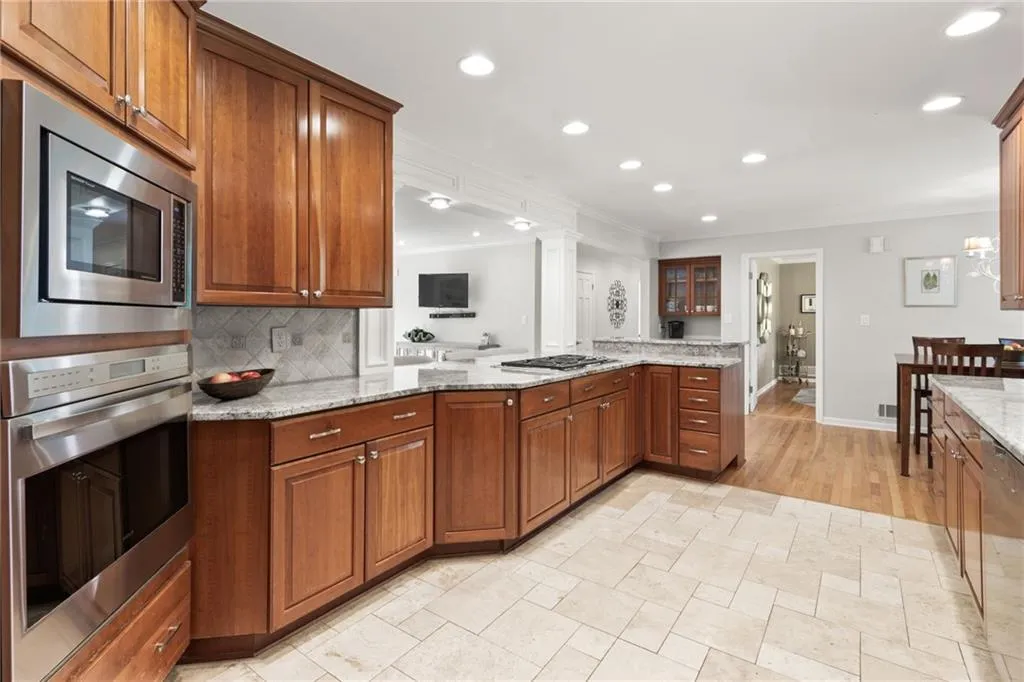 All stainless appliances with a separate gas cooktop and recessed lighting