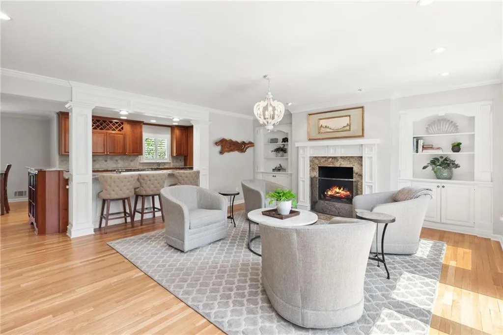 Family room with built-ins and fireplace adjoin kitchen