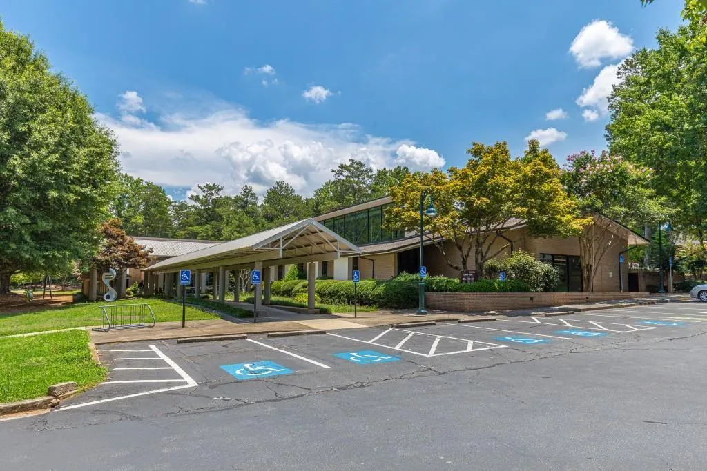 View of parking featuring a lawn