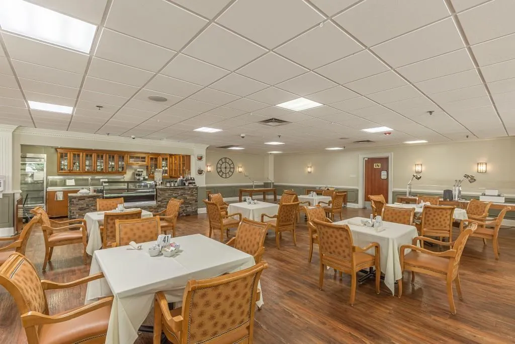 Dining area with hardwood / wood-style floors and a paneled ceiling