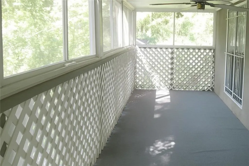 Unfurnished sunroom with ceiling fan and healthy amount of natural light