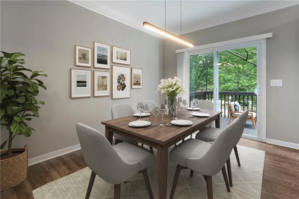Dining area with ornamental molding and wood finished floors