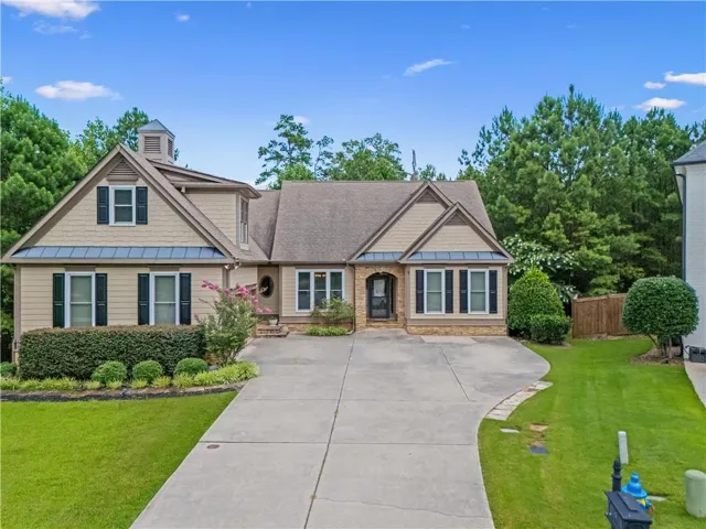 Traditional style residence featuring a prominent cupola and dormer window