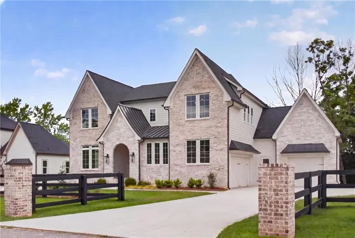 Showcasing entrance with brick columns and estate fence