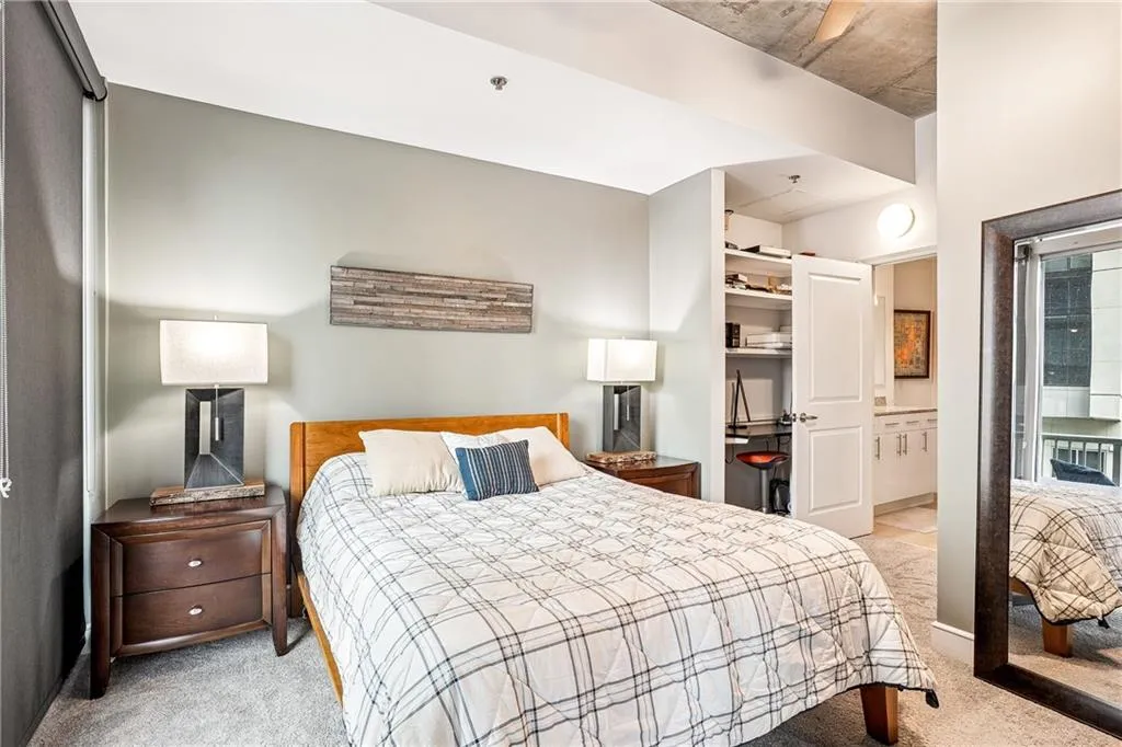 Bedroom featuring light colored carpet and a closet