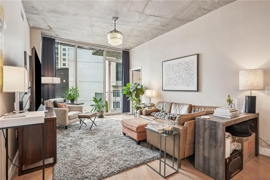 Living area with expansive windows and light wood-type flooring