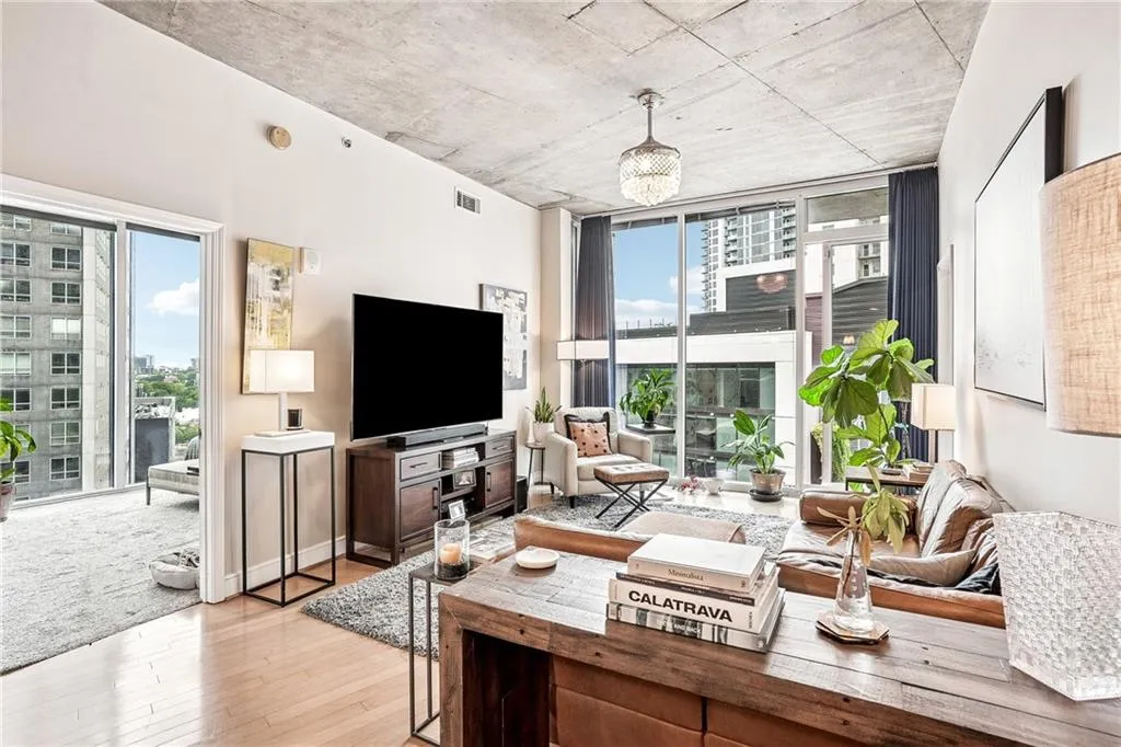 Living area featuring light wood-style floors and a wall of windows