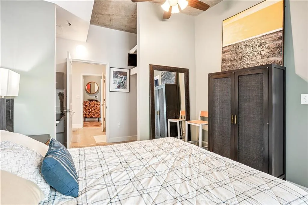 Bedroom featuring ceiling fan and ensuite bath