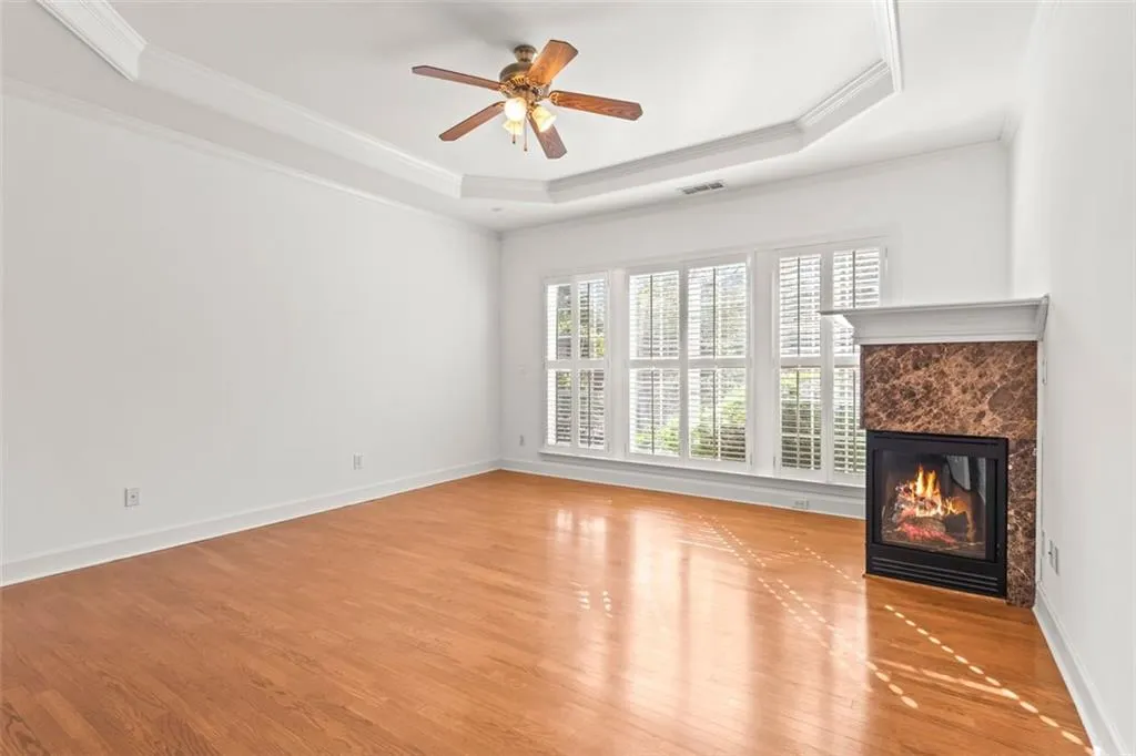 Corner fireplace is a focal point of this primary bedroom