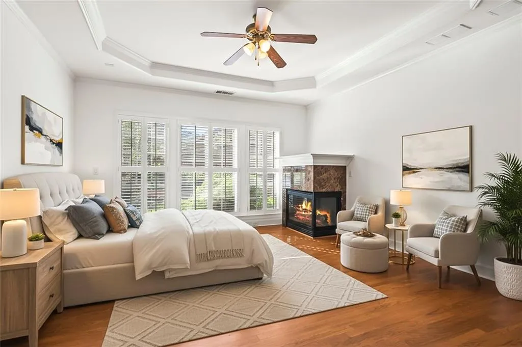 Spacious primary suite with picture window and corner fireplace