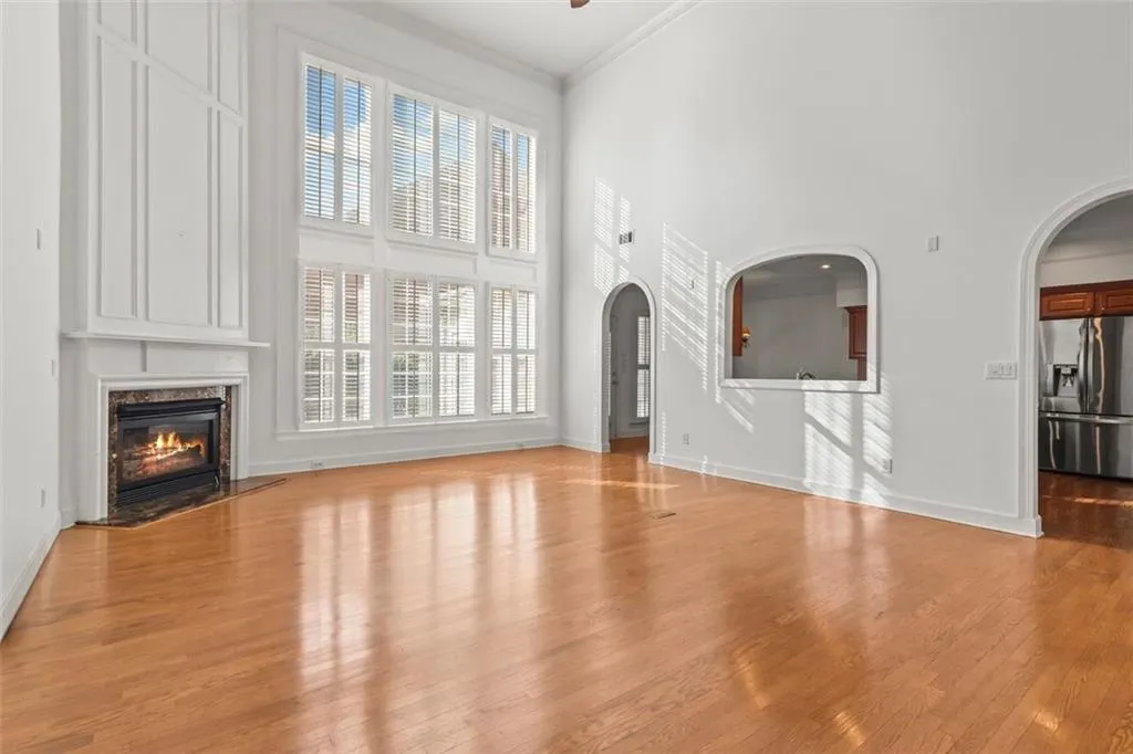 Enter this spacious great room with floor to ceiling windows!! Beautiful arches!