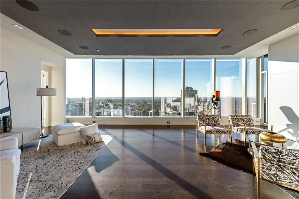 Expansive Entertainment room with floor to ceiling windows