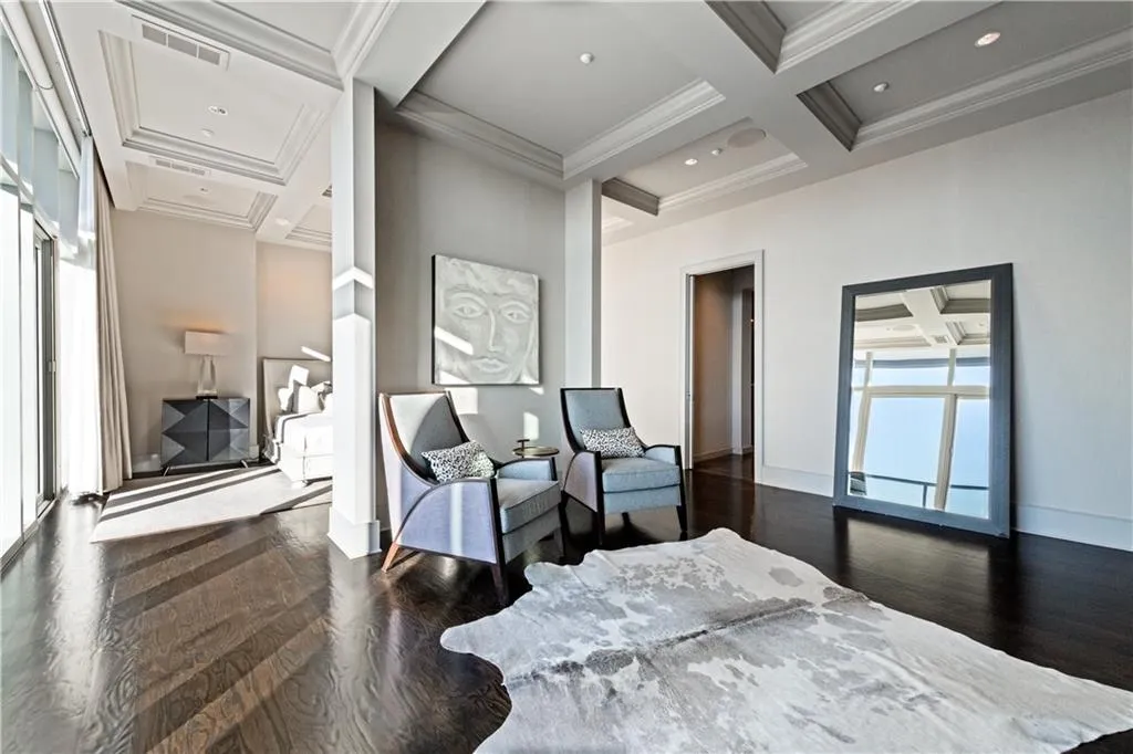 Bedroom with coffered ceiling, beam ceiling hardwood flooring, and ornamental molding