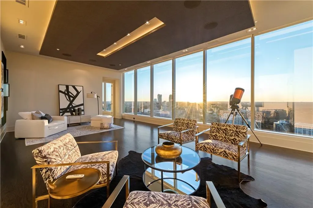 Expansive entertaining area with floor to ceiling windows, a stylish bar with a large wine fridge, refrigeration and ice drawer