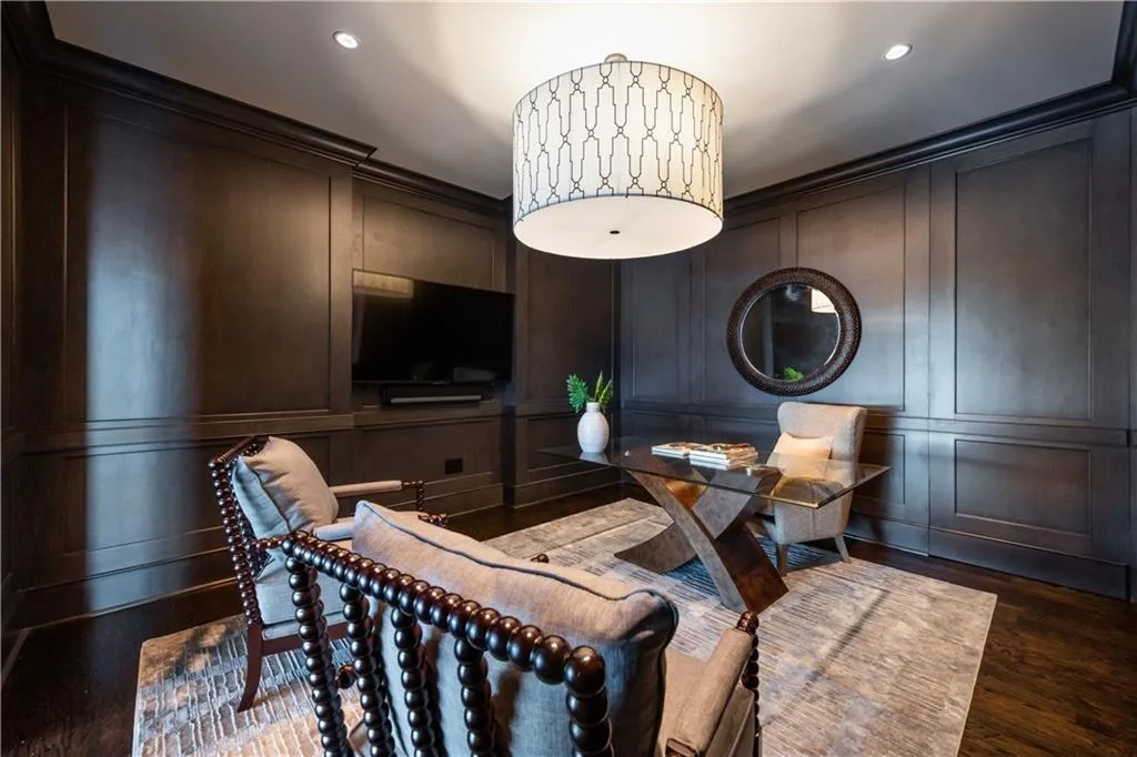 Private office with rich wood-paneled walls, sliding pocket doors offering privacy and stunning skyline views