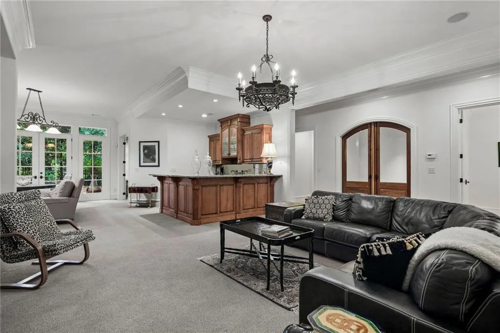 Built-in wood cabinetry with stone countertop, double French doors leading to terrace Patio