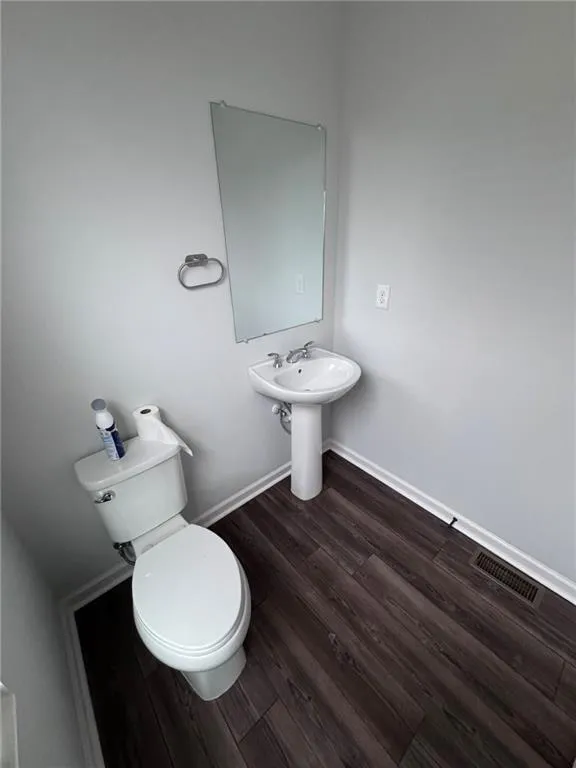 Bathroom with wood finished floors and baseboards
