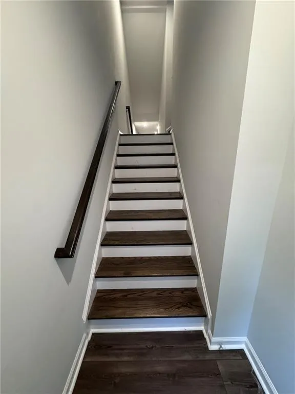 Stairs featuring baseboards and wood finished floors