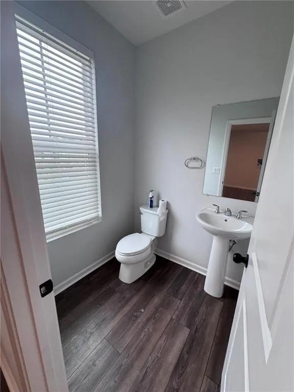Bathroom featuring dark wood-type flooring and baseboards