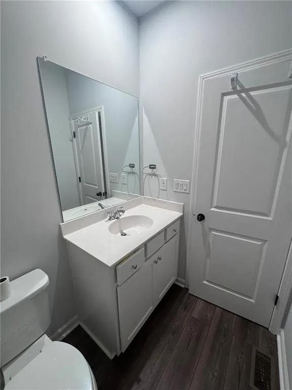 Bathroom featuring dark wood finished floors and vanity