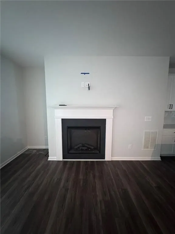 Detailed view of wood finished floors and a fireplace