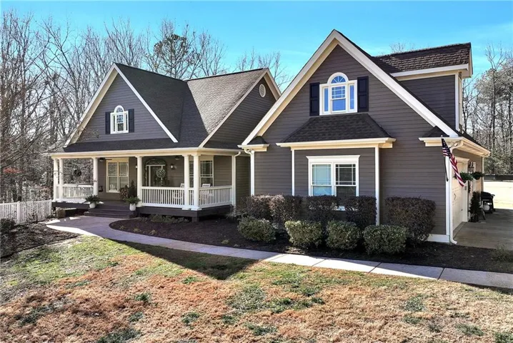 View of front of house featuring a porch and roof with shingles