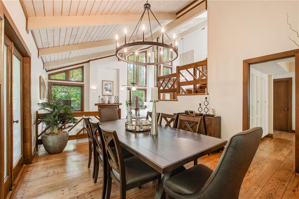 Banquet size dining room with a beautiful chandelier is open to the fireside living room