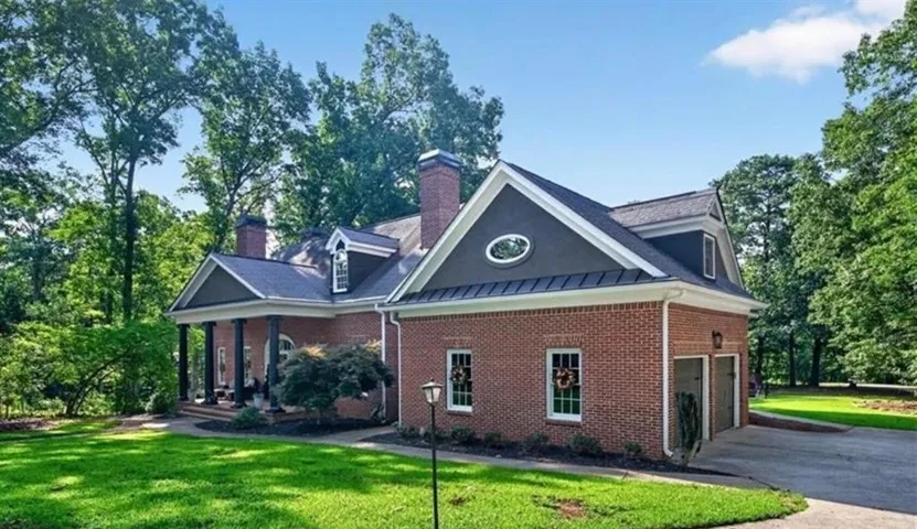 Traditional brick exterior with dark trim and white window frames